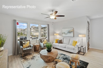Living room featuring ceiling fan and light wood-type flooring