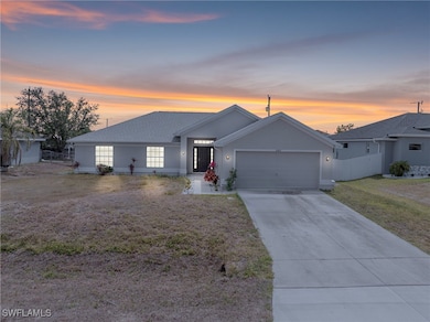 Ranch-style house featuring a garage, concrete dri