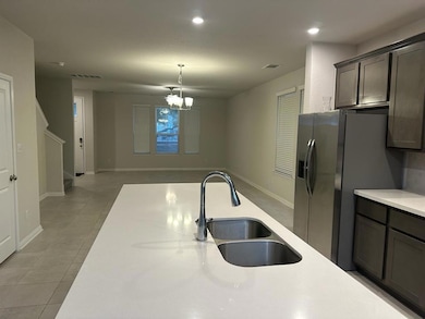 Kitchen featuring a sink, stainless steel fridge 