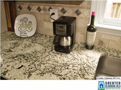 Granite and Custom Black Splash make this home abs
