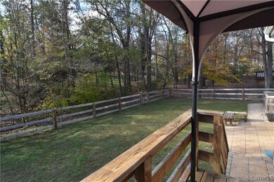 The level, fenced back yard backs up to Woodlake c