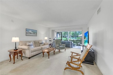 Living room featuring light colored carpet