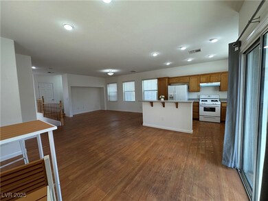 Kitchen with open floor plan, a kitchen bar, white