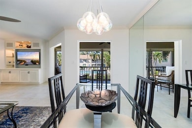 Dining area featuring visible vents, ceiling fan with notable chandelier, crown molding, light tile patterned floors, and lofted ceiling