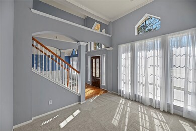 Flanked on the other side of the entry is this formal living room that could easily be a home office, workout space or downstairs play area!