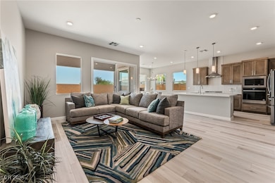 Living area with light wood-style flooring, recessed lighting, and baseboards
