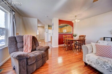 Living room with wood-type flooring and an invitin