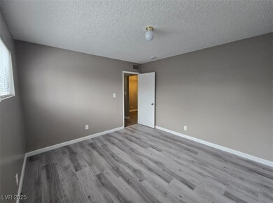 Unfurnished room with wood finished floors, basebo