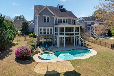 Rear view of property with a sunroom, a patio, sta