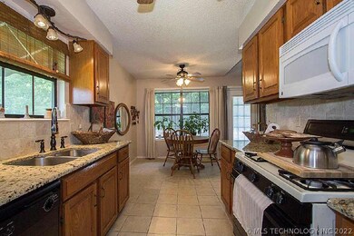 Kitchen has granite counters and beautiful tile fl