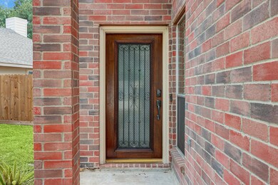 The beautiful front door is a rich mahogany with glass and iron detail.  What a welcoming touch.