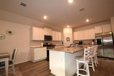 spacious kitchen with granite and plenty of cabinets