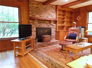 Family room has wood burning fireplace and built-i