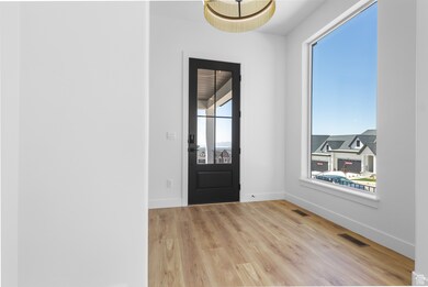 Foyer entrance with light wood finished floors and baseboards