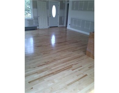 Living Room. Beautiful maple floors in living room