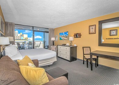 Carpeted bedroom with floor to ceiling windows, a textured ceiling, and access to outside