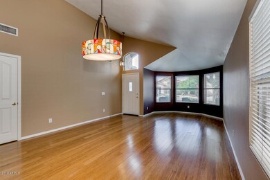 Formal living room with vaulted ceilings