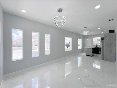Unfurnished living room with a chandelier, recessed lighting, and light marble finish floors