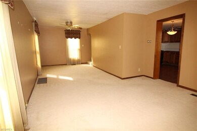 Spacious living room with neutral dcor leads from 