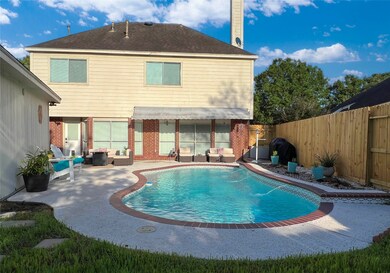 Inviting oasis awaits with a gleaming pool and ele