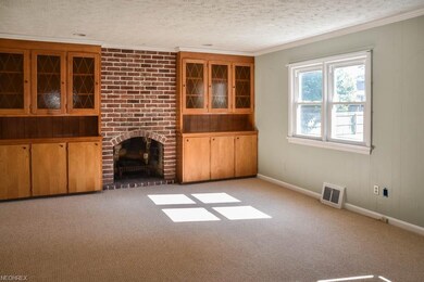 Family room addition featuring a brick fireplace f