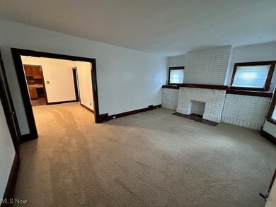 Unfurnished living room featuring light colored carpet and a​​‌​​​​‌​​‌‌​​​‌​​‌‌​​‌‌​‌​​​‌‌​​‌​​​​​‌ fireplace
