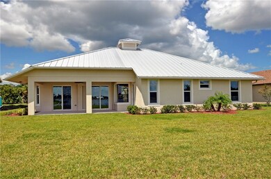 Rear of home with covered open porch that looks ou