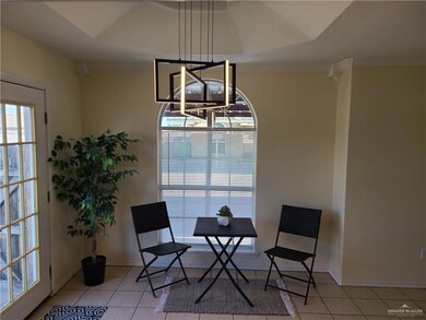 Living area featuring light tile patterned floors and ornamental molding