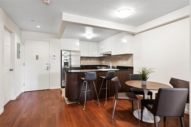 Kitchen with sink, dark hardwood / wood-style floors, stainless steel refrigerator with ice dispenser, backsplash, and white cabinets