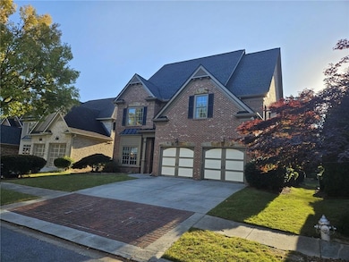 View of front of house with driveway, an attached garage, a front yard, and brick siding