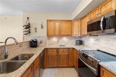Kitchen featuring sink, decorative backsplash, app