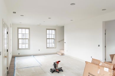 Spare room featuring plenty of natural light, stairs, and recessed lighting