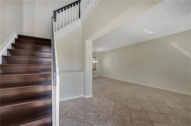 Wood stairs lead to second floor from entry
