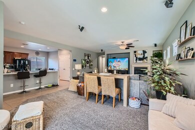 Living room featuring ceiling fan, light tile patt