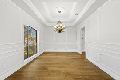 Formal dining room with hardwood floors, an elegan