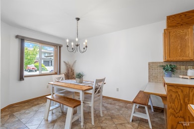 Dining area featuring a chandelier and light tile patterned flooring