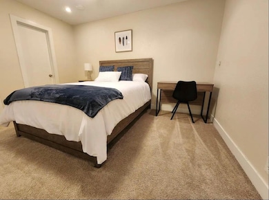 Bedroom featuring baseboards and carpet