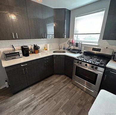 Kitchen has custom cabinetry and quartz countertops