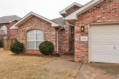 View of exterior entry with a yard and a garage