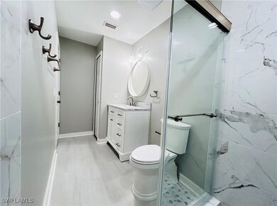 Master Full bath with toilet, a shower stall, visi