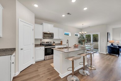 Kitchen featuring a sink, visible vents, appliance
