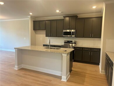 Kitchen with appliances with stainless steel finishes, light wood-type flooring, tasteful backsplash, ornamental molding, and recessed lighting