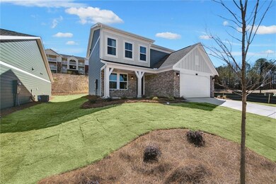 View of front of house with brick siding, board an