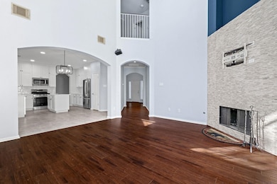 Unfurnished living room featuring a stone firepla