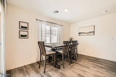 Dining space with wood finished floors and baseboards