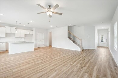 Unfurnished living room featuring baseboards, ceil