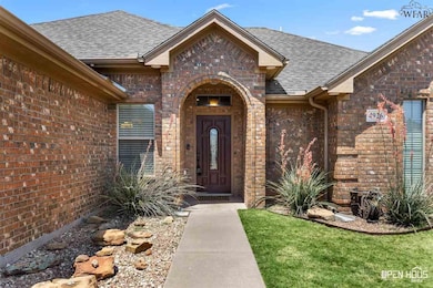 Well-maintained landscaping and covered front porch.