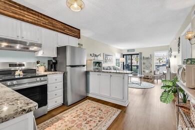 Kitchen featuring white cabinets, a peninsula, sta