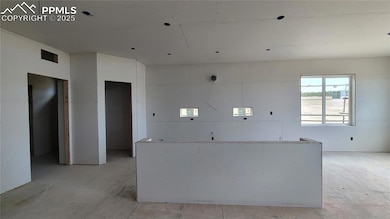Kitchen with quartz slab countertops, pantry, large island providing additional seating, and stainless steel gas range, pyramid hood, microwave drawer, and dishwasher! Please, excuse our dust as this home is currently under construction.