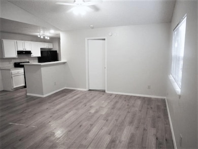 Kitchen with a ceiling fan, a textured ceiling, r